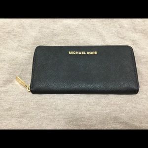 Lightly used black MK wallet with zip closure
